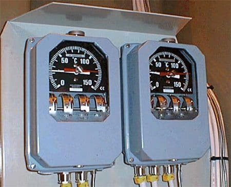 Top-oil thermometer and winding thermometer main units fitted on the side of a power transformer