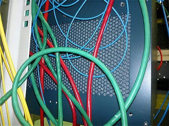 Cables Obstructing the Air Grid on the side of a Cisco Data Networking Equipment