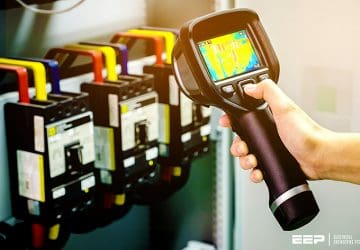 A Basic Guide to Thermography Method Of Inspecting Electrical Equipment (on photo: Technician use thermal imaging camera to check temperature in factory)