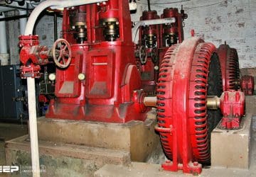 A pair of ancient Carbon Dioxide air conditioning compressors, powered by two antique 150 horsepower open frame synchronous motors