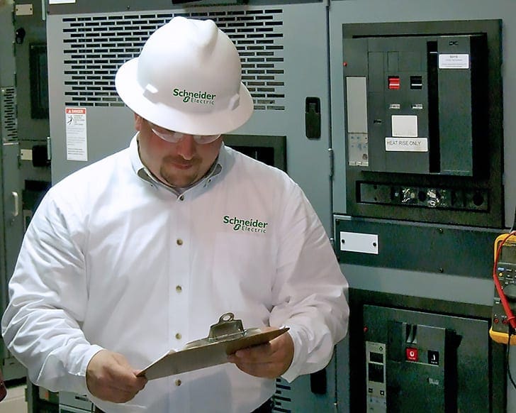 Engineer performing verification of LV switchgear against specifications