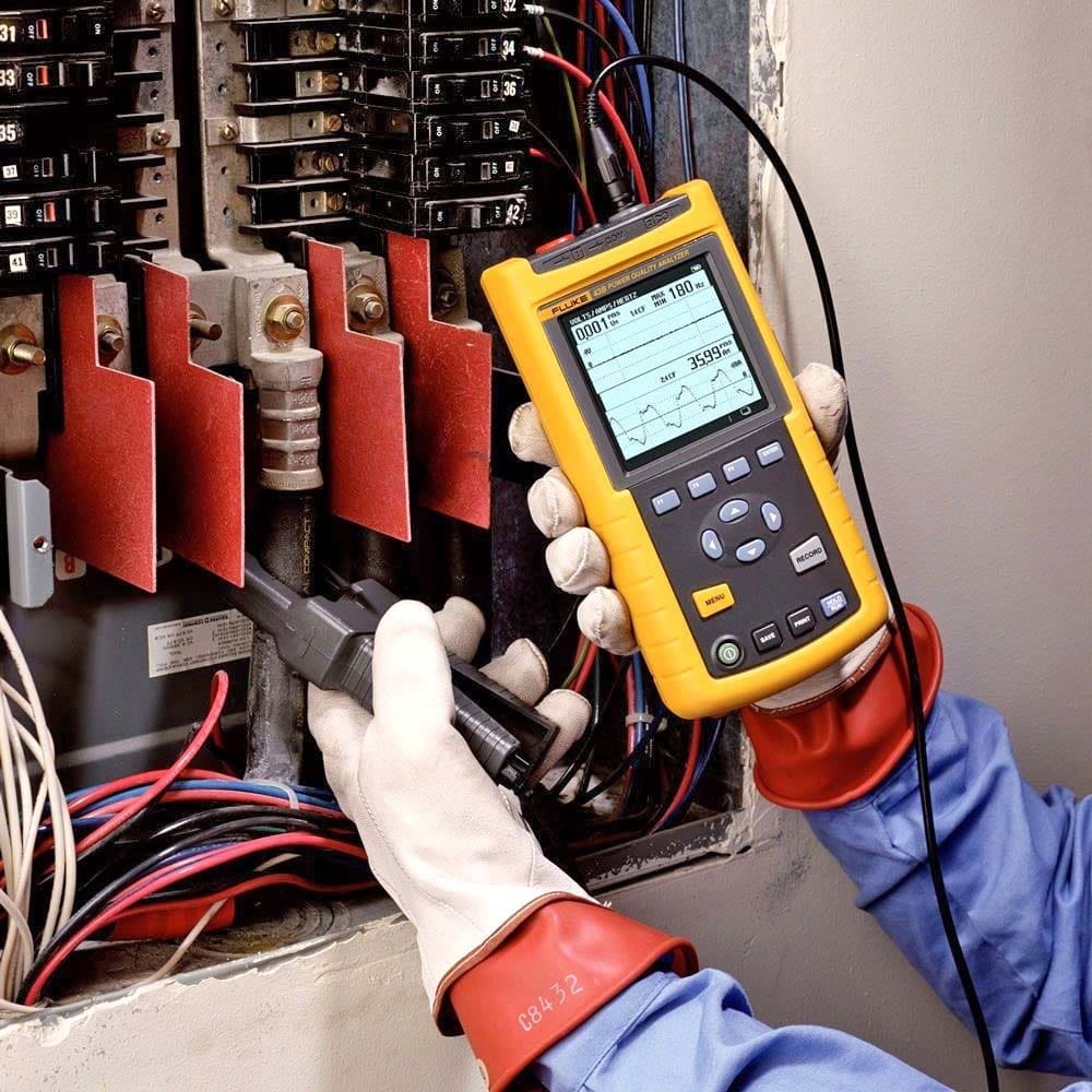 Handheld harmonic analyzer showing voltage leads and current probe for voltage and current harmonic measurements