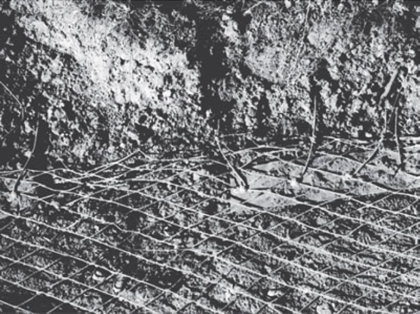 Ground system inspection: Small pieces of copper strap were used in this ground system to attach radials to the ground screen around the base of a tower.