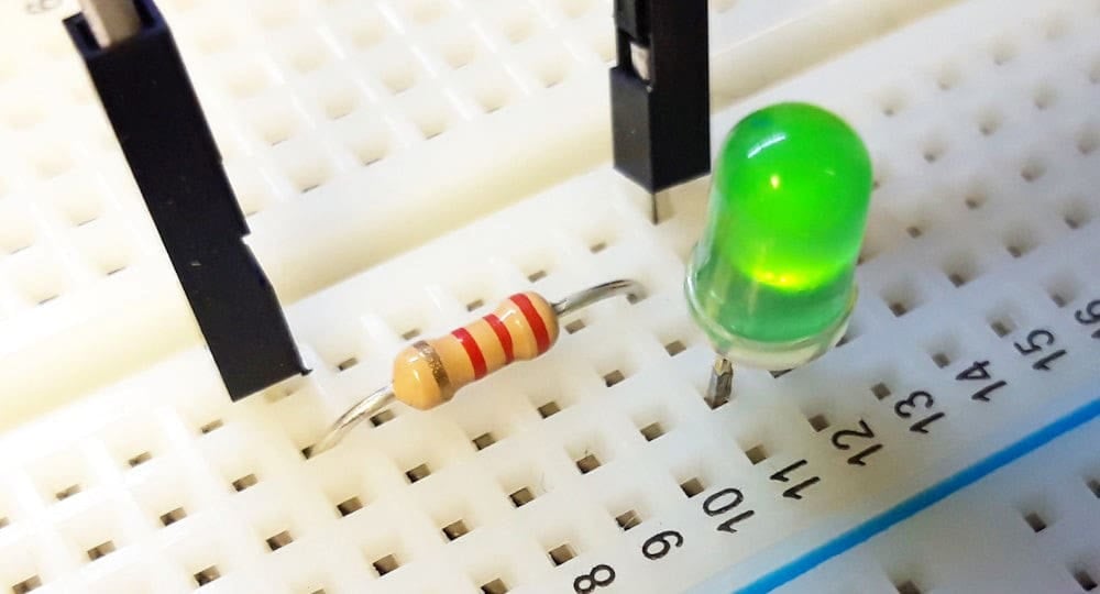 The battery, resistor, and LED are physically connected on the breadboard using wires