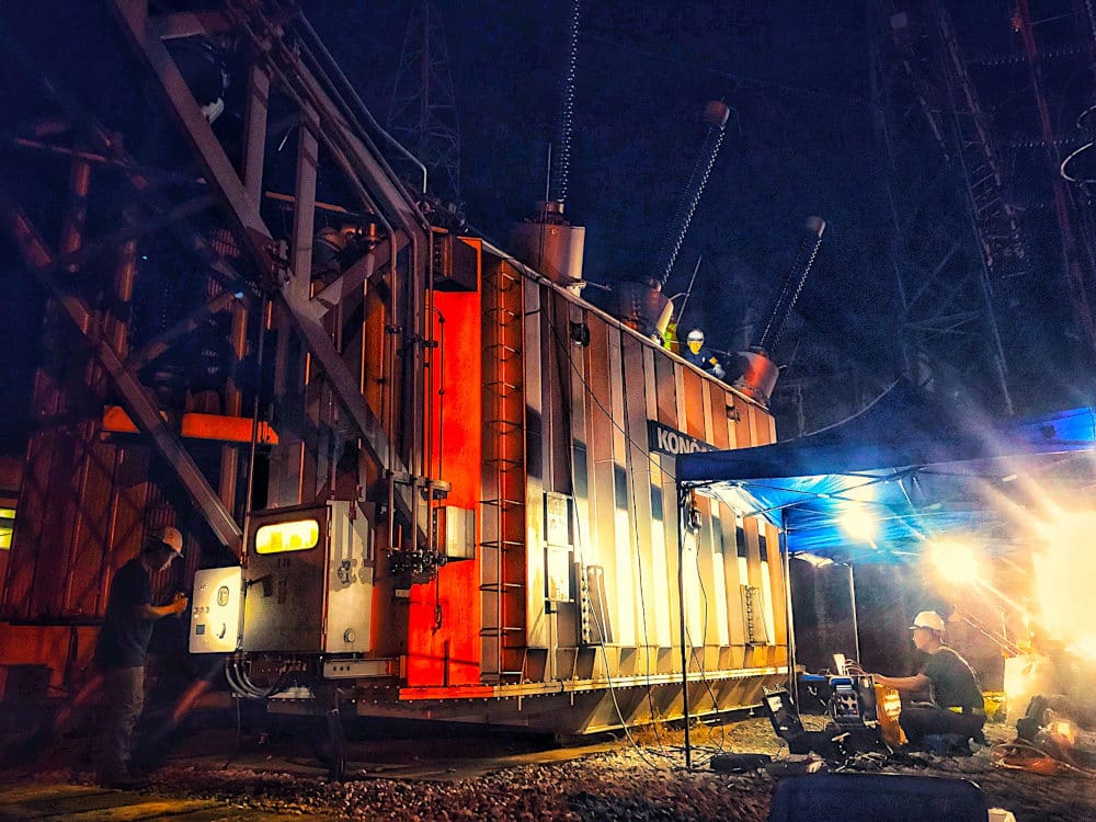 Testing and commissioning engineers in action of testing power transformer at night