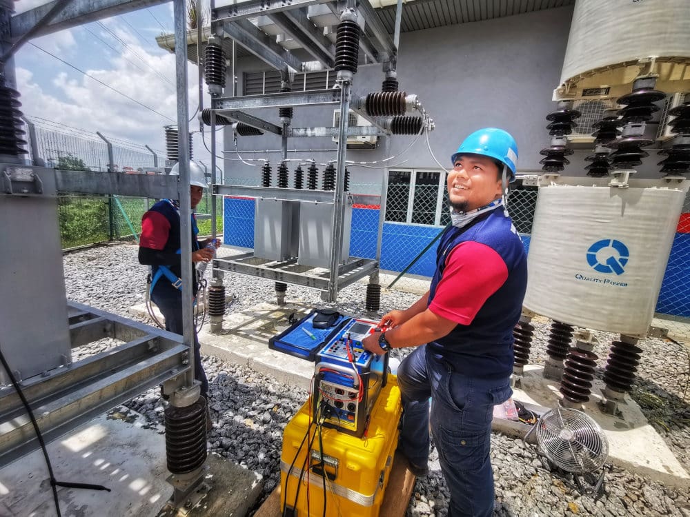 Engineer performing testing and commissioning of HV capacitor banks